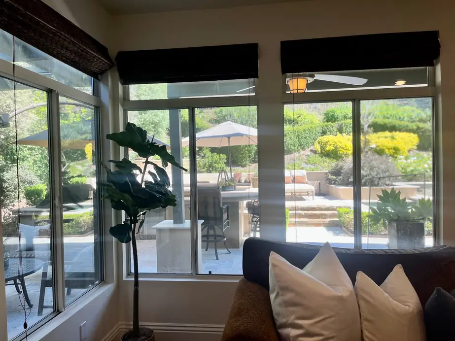 Clean sunroom windows looking onto a garden and patio